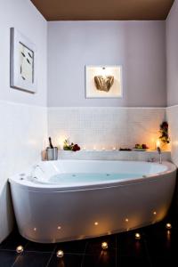 a white bath tub in a bathroom with lights at Boutique Hotel Nautilus in Tábor