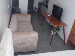 a living room with a couch and a tv and a table at A006 Ss2 in Kiambu