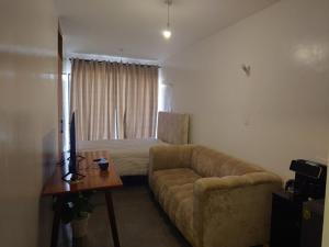 a living room with a couch and a bed at A006 Ss2 in Kiambu