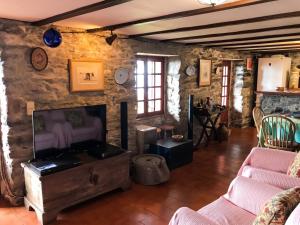 a living room with two couches and a fireplace at Sea-view house in Fajã da Ovelha with garden and terrace in Fajã da Ovelha