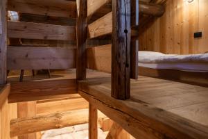 a wooden room with two bunk beds in it at Agriturismo Piccola Baita in Falcade