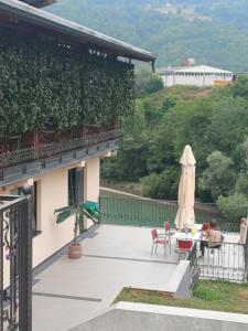 a balcony of a house with a table and chairs at Apartmani Nešković Foča in Foča