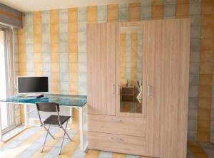 a wooden cabinet with a desk and a computer at Studio charmant dans Brioude – 25 m² avec terrasse et parking in Brioude +9 photos