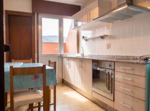 a kitchen with a table and a counter top at Welcoming Apartment in A Coruña, 90 m², Balcony in Serres