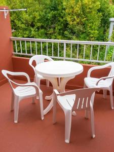 a white table and chairs on a balcony at Welcoming Apartment in A Coruña, 90 m², Balcony in Serres