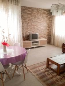 a living room with a purple table and a tv at Welcoming Apartment in A Coruña, 90 m², Balcony in Serres +21 photos