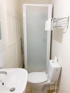 a white bathroom with a toilet and a sink at Studio moderne à Néris-les-Bains de 17 m² in Néris-les-Bains