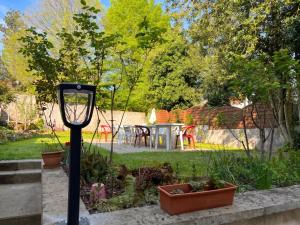 a garden with a table and chairs in the background at Studio moderne à Néris-les-Bains de 17 m² in Néris-les-Bains