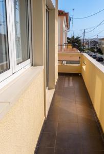 a balcony with a window and a tile floor at Comfortable Apartment in Feijó with Shared Pool, 90 m² in Almada