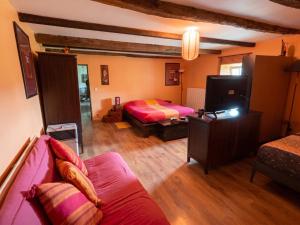 a living room with a bed and a couch at Appartement spacieux à Chenevrey-et-Morogne 160 m² avec terrasse in Chenevrey-et-Morogne