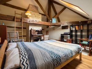 a bedroom with a bed in a room with wooden ceilings at Appartement spacieux à Chenevrey-et-Morogne 160 m² avec terrasse in Chenevrey-et-Morogne +10 photos
