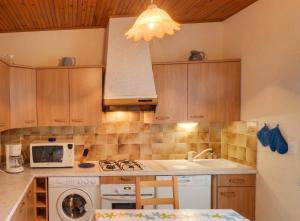 a kitchen with a sink and a stove top oven at Appartement avec piscine à Montpezat-de-Quercy 40 m² in Montpezat-de-Quercy