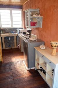 a kitchen with a sink and a counter in a room at Bungalow cosy à Saint-Leu, vue sur la mer. in Saint-Leu