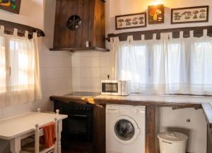 a kitchen with a washing machine and a microwave at Spacious Apartment in Yeste with Shared Pool in Yeste