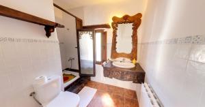 a bathroom with a toilet and a sink and a mirror at Spacious Apartment in Yeste with Shared Pool in Yeste