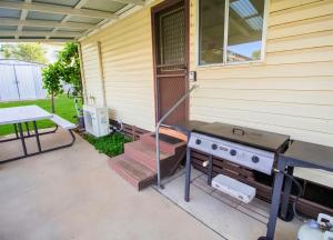 a barbecue grill on the side of a house at Manilla Cottage - Manilla NSW in Manilla