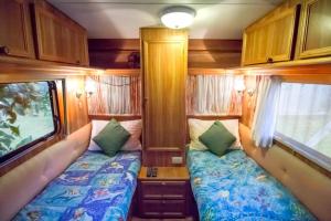 a small room with two beds and a tv at Manilla Cottage - Manilla NSW in Manilla