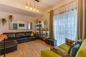 a living room with a couch and a table at Avenue View Rooms in Porto