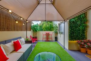 an outdoor patio with a couch and grass at Avenue View Rooms in Porto
