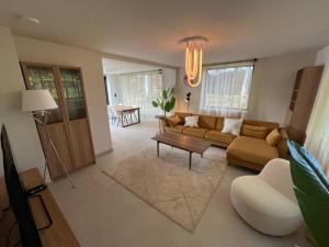 a living room with a couch and a table at Villa Médard in Bruges