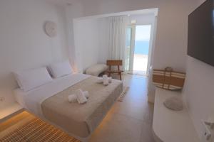 a bedroom with a bed with two towels on it at Three Drops in Kanala +48 photos