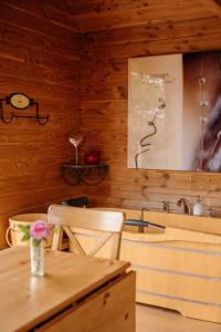 a dining room with a table and a sink at Cabane Pomme d'Amour in La Chapelle-Bouexic