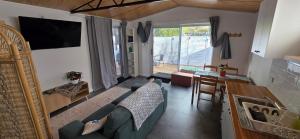 a living room with a blue couch and a table at Studio in Quindalup bay in Quindalup