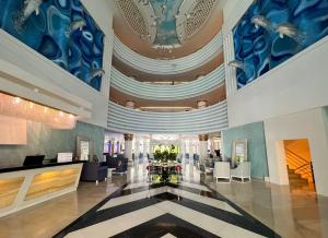 a lobby of a hotel with a blue and white ceiling at Catamaran Quality Times - Premium Ultra All Inclusive in Kemer +42 photos