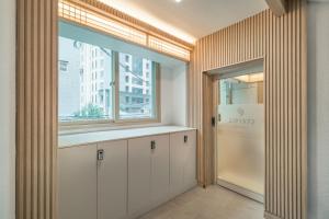 a kitchen with white cabinets and a window at ZIP 1972 DDP two-min from airport bus station 4-min from DDP subway station in Seoul
