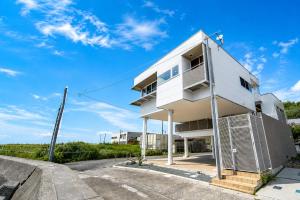 a man standing on top of a white building at VillaMer KAWACHI in Kumamoto