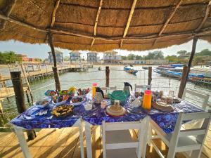 a table with food on it with a view of the water at Hotel Cap du Sine Saloum in Ndangane