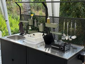 a kitchen counter with a sink and a mixer and utensils at Canopy Villa Nuang Hill in Bentong +72 photos