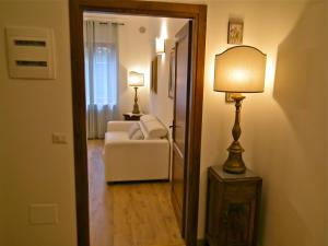 a hallway with a living room with a couch and a lamp at Suite Umberto I in Assisi