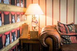 a lamp sitting on a table next to a chair at Hôtel du Théâtre by Patrick Hayat in Paris