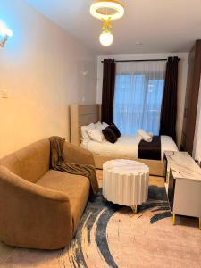a living room with a couch and a bed at Tsavo rising in Nairobi