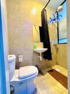 a bathroom with a toilet and a sink at Tsavo rising in Nairobi