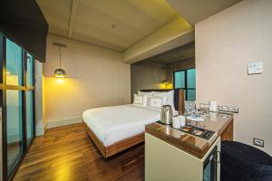 a hotel room with a bed and a desk with a kitchen at The Haze Karaköy in Istanbul