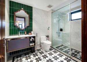 a bathroom with a toilet and a glass shower at Diamond Hotel Yen Bai in Yên Bái +67 photos