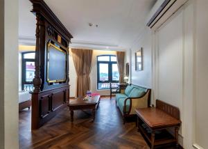 a living room with a couch and a tv at Diamond Hotel Yen Bai in Yên Bái