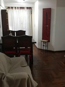 a living room with a bed and a table and a window at Departamento en Nueva Cordoba in Córdoba