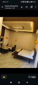 a bedroom with a bed in a room with a couch at A7 hotel in Khanna