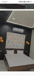 a room with two beds and a projector on the wall at A7 hotel in Khanna