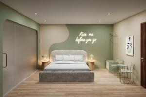 a bedroom with a bed and a sign that says hug me before you go at Sanora Hotel in Hanoi