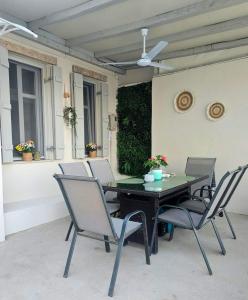 a black table and chairs on a patio at Villa Aktaia in Keramídhion +19 photos