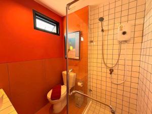a bathroom with a toilet and a glass shower at STAY Standard HOTEL Kohlarn in Ko Larn