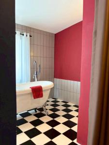 a bathroom with a tub and a checkered floor at STAY Standard HOTEL Kohlarn in Ko Larn +77 photos