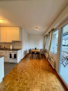 a kitchen and dining room with a table and chairs at Basic Apartment in Witikon district in Zurich