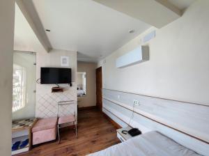 a bedroom with a bed and a tv on the wall at The Town Boho in Shimla