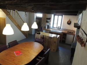a kitchen and dining room with a wooden table and chairs at Gite Grand-Mère in Charron