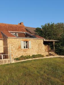 a brick house with a window and a yard at Gite Grand-Mère in Charron